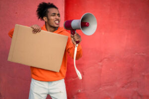 mixed race man holding a loudhailer