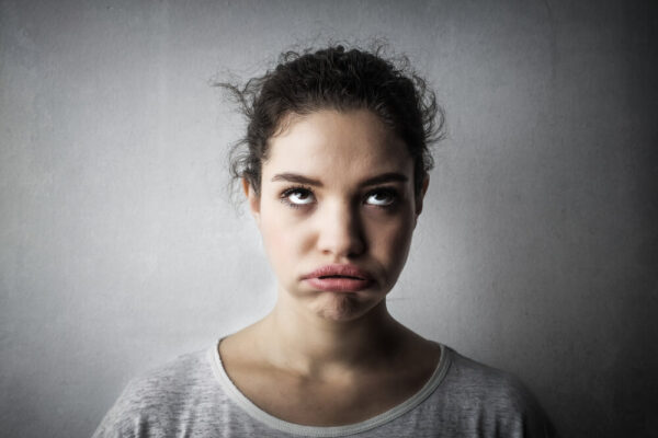 Young woman looking bored.